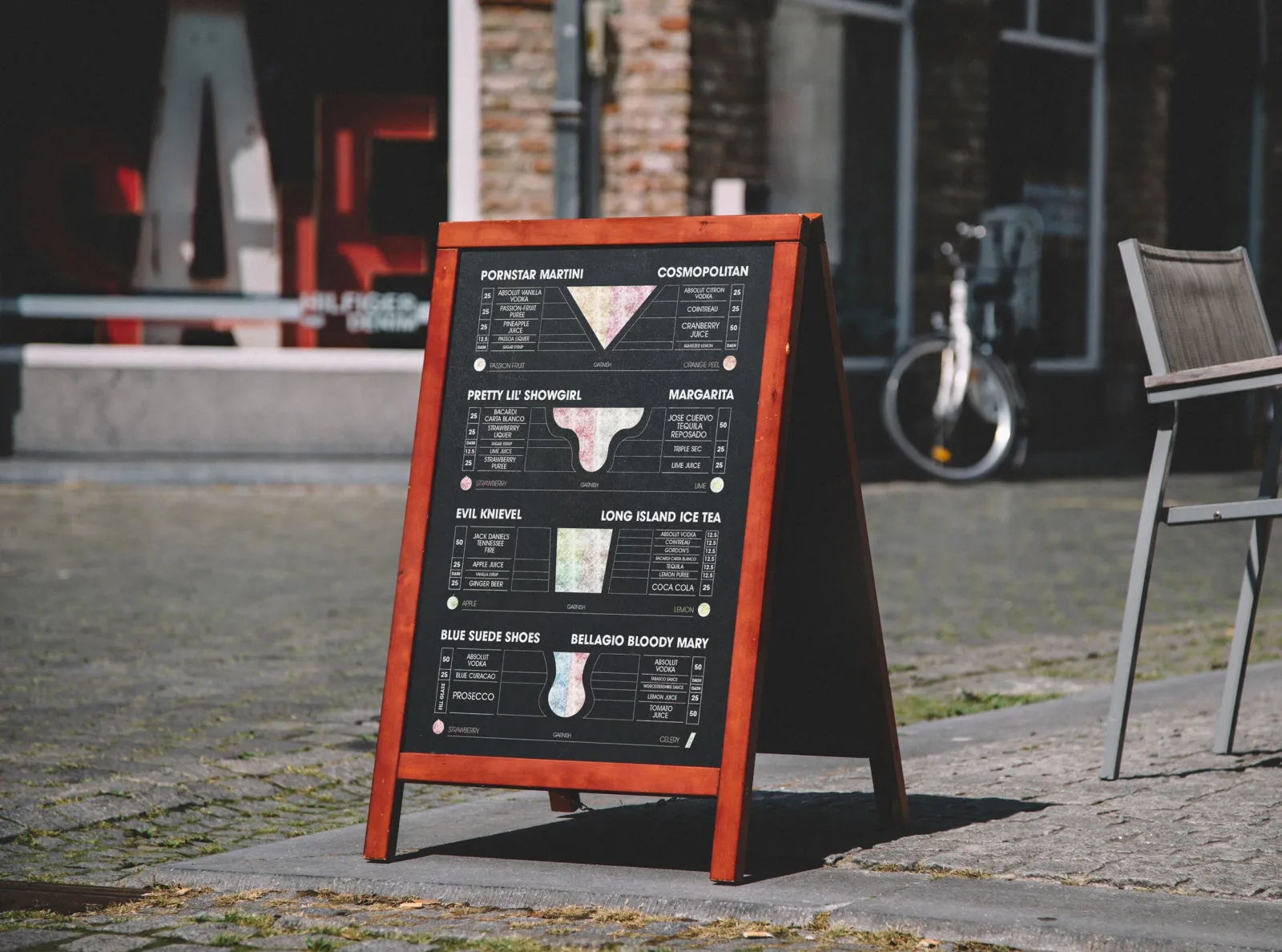 The same sheet as an A-board outside a bar, the icons in white on black.
