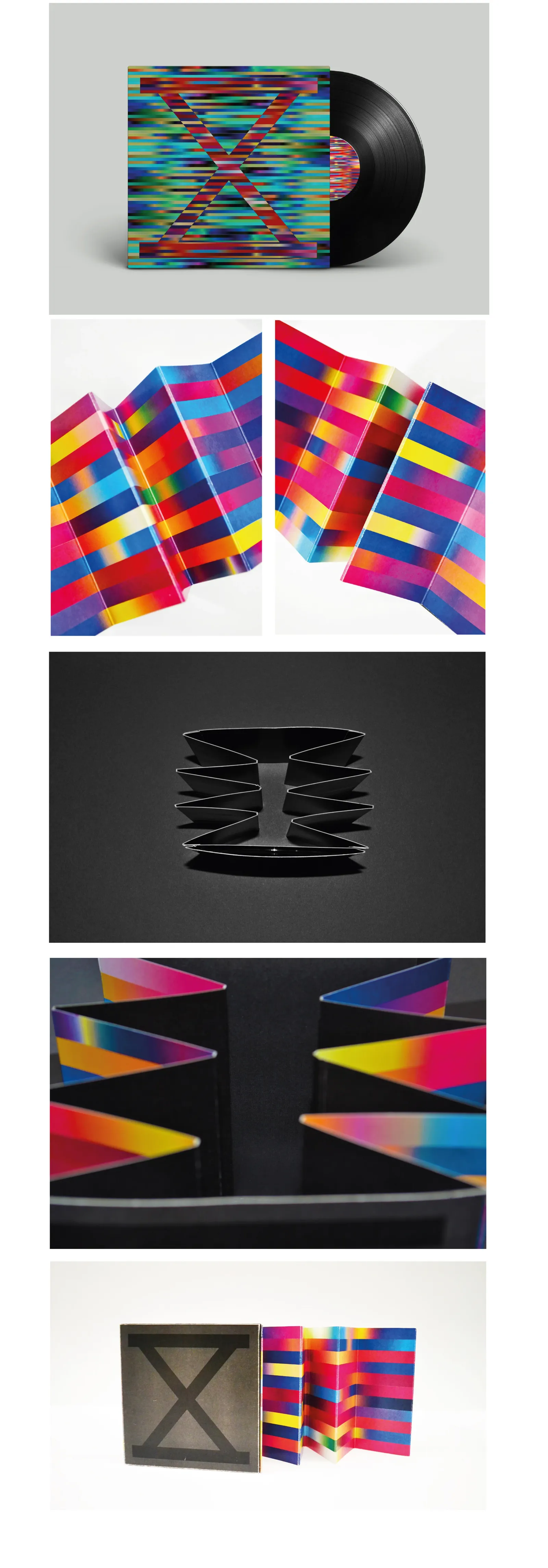 The same package photographed further: the record in its striped sleeve, the concertina standing open, and the folds lit from the side against black so the zig-zag reads as a structure.