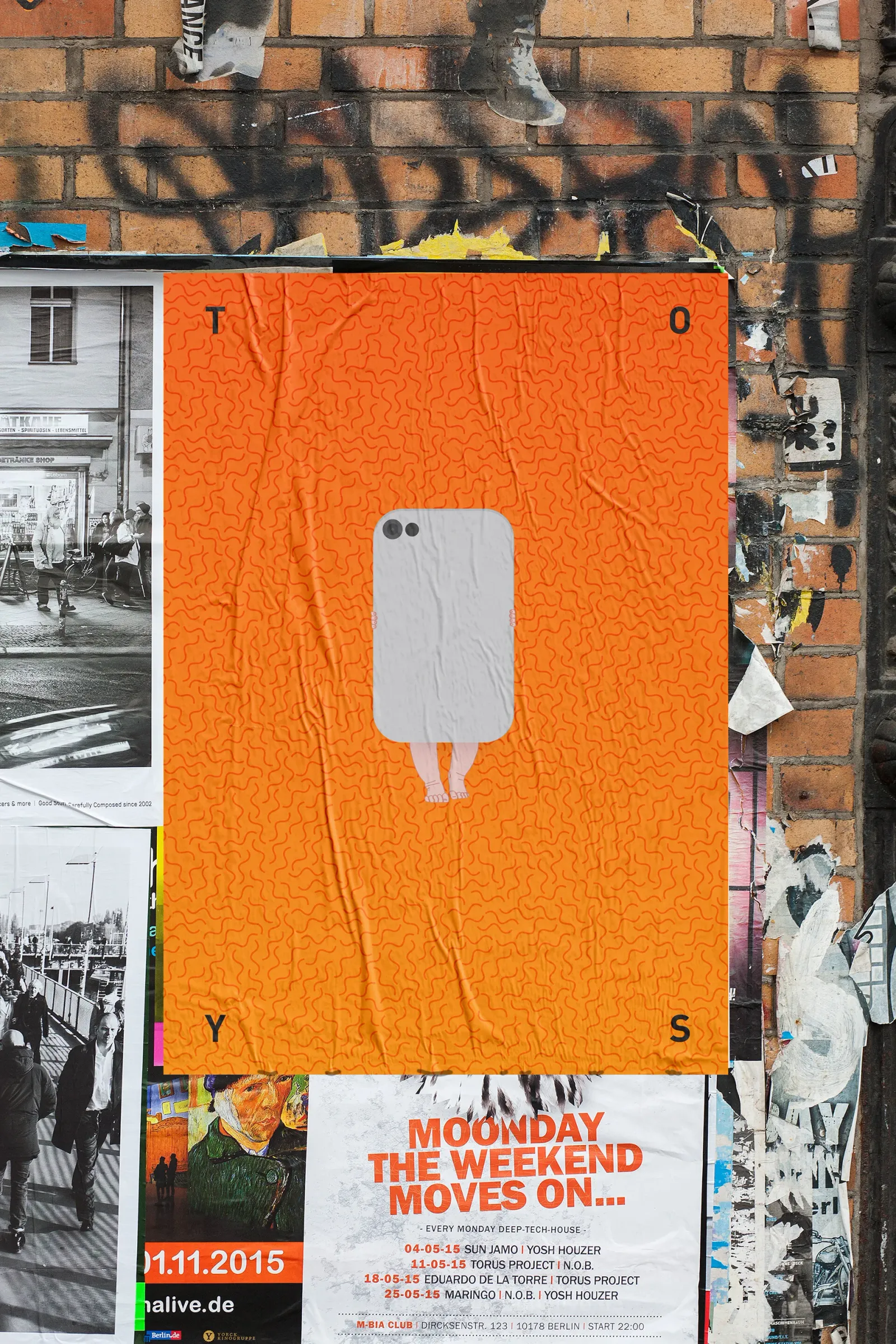 An orange poster of the series pasted on a hoarding among other bills.