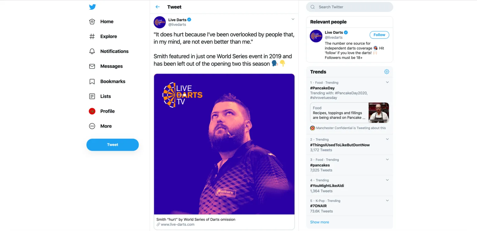A Live Darts TV social post in a Twitter timeline, a player photographed in purple and orange.