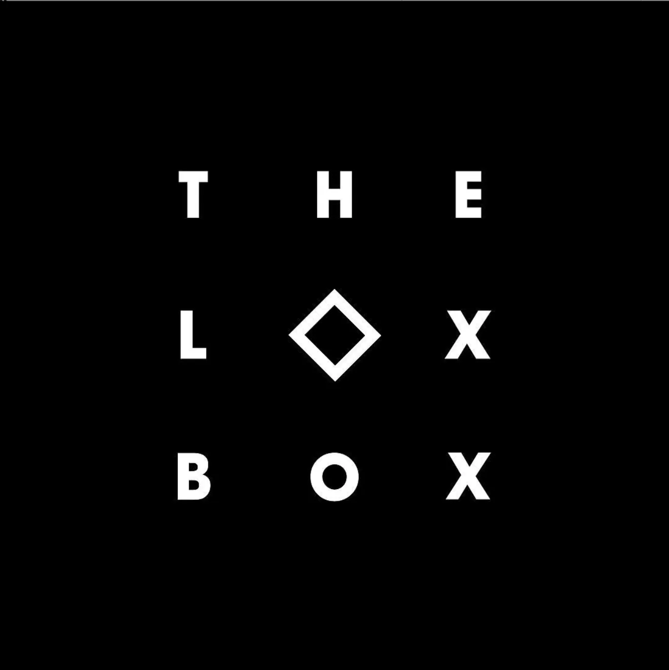 A logotype for The Lox Box, the words set in spaced white capitals around a diamond outline, on black.